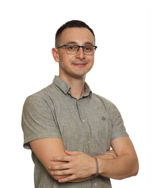Stefan, an English teacher, wearing a short-sleeved shirt.